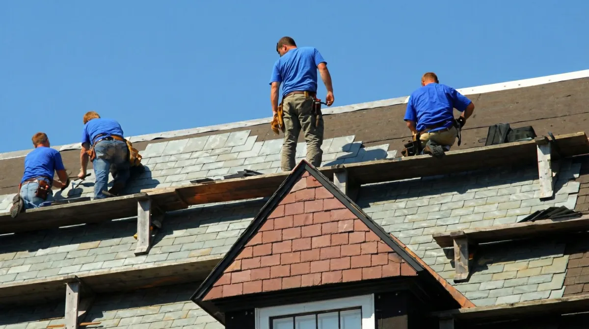 Roof replacement in progress with a team of professional contractors installing new shingles on a residential home in Boise, ID